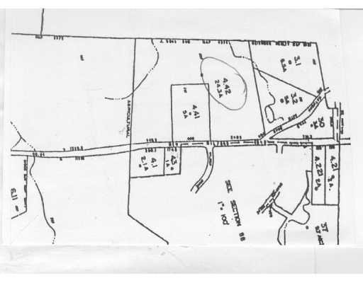 a picture of a room with table and white walls