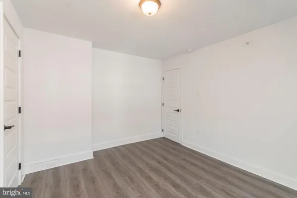 a view of a room with wooden floor