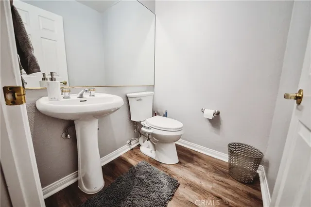 a bathroom with a sink toilet and a mirror