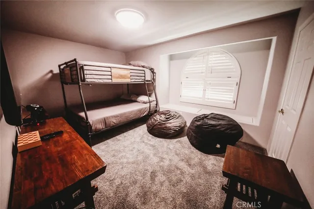 a bedroom with bed and window