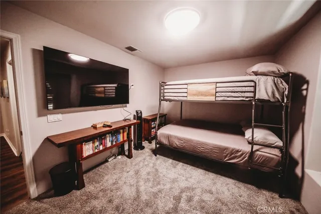 a bedroom with furniture and a flat screen tv