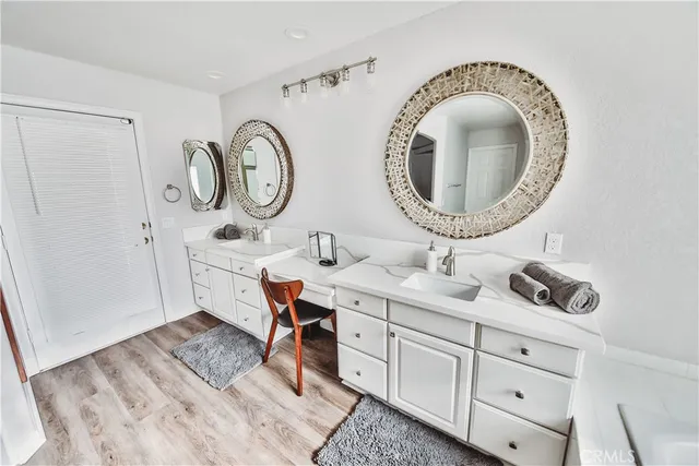 a bathroom with a double vanity sink and a mirror