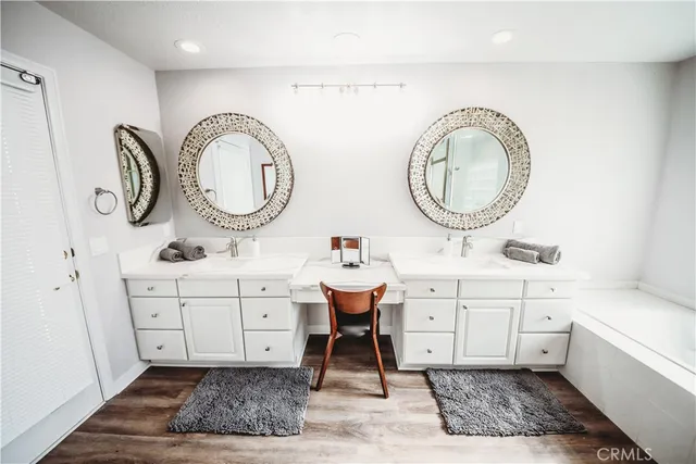 a spacious bathroom with a double vanity sink a mirror and a