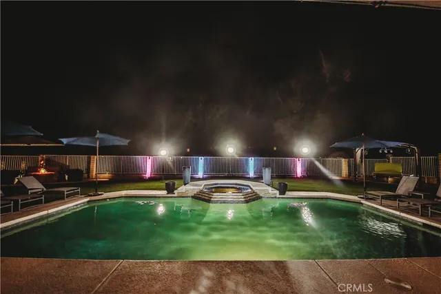 a swimming pool view with a outdoor seating space