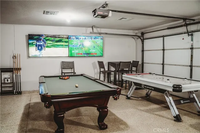 a room with furniture pool table and window