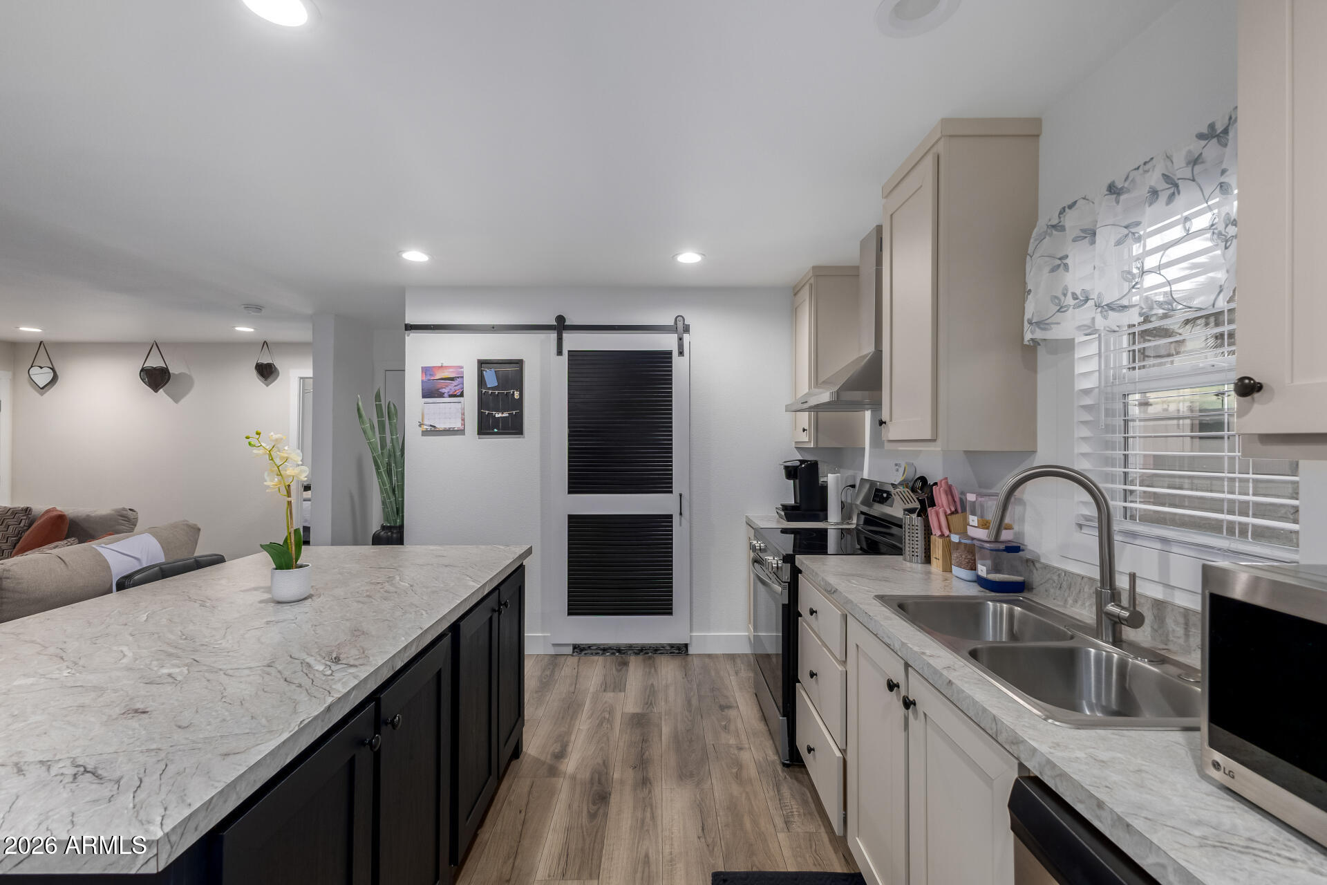19401 North 7th Street, Unit 73 Phoenix, AZ 85024 - Photo 15 of 30 a kitchen with granite countertop a sink and cabinets