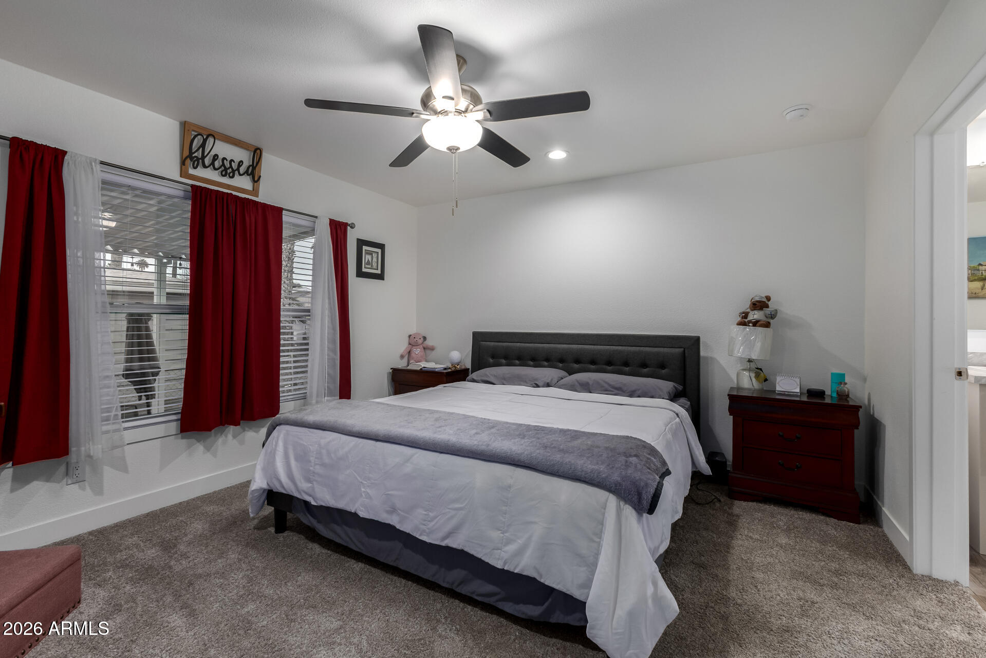 19401 North 7th Street, Unit 73 Phoenix, AZ 85024 - Photo 17 of 30 a spacious bedroom with a bed and a chandelier