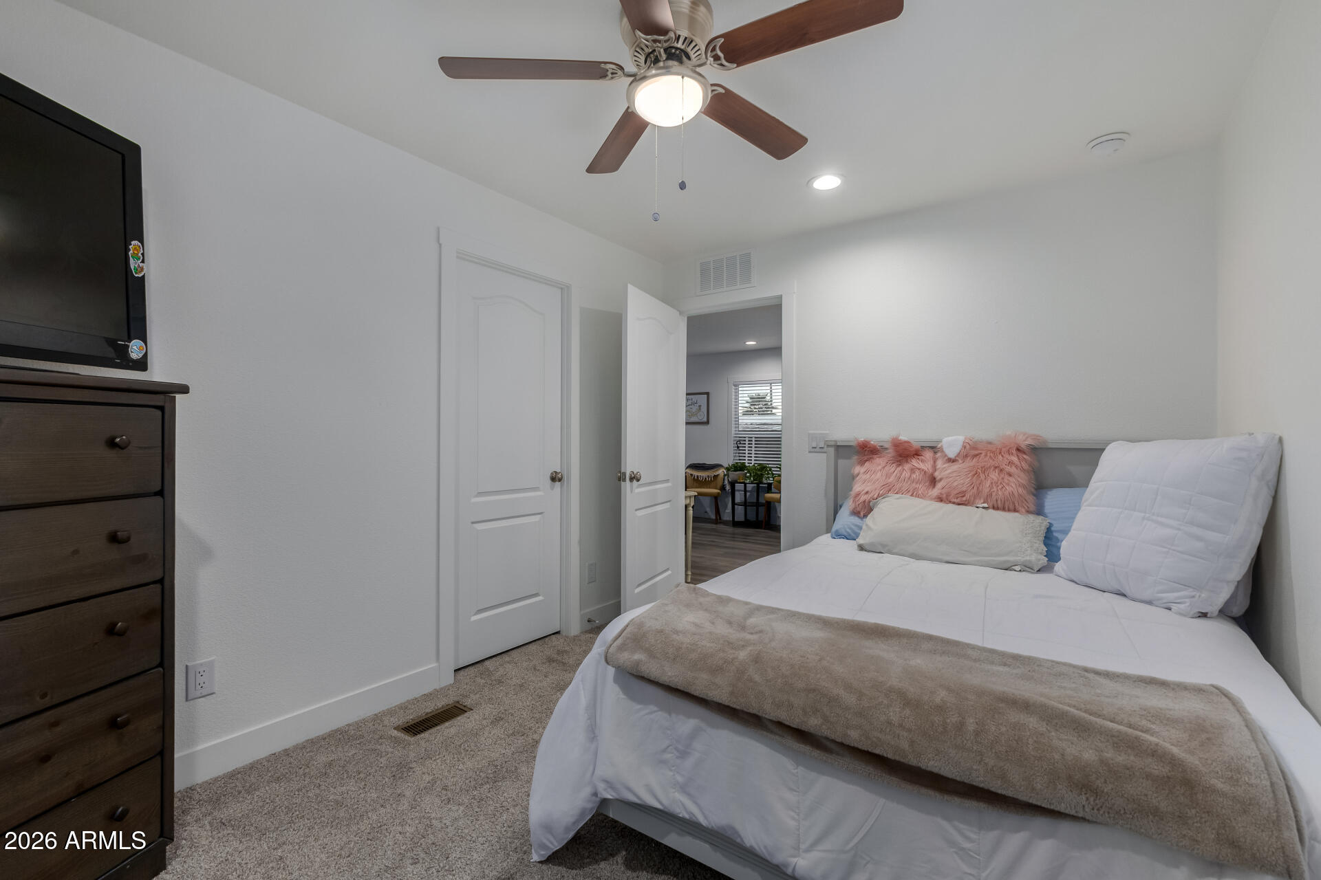19401 North 7th Street, Unit 73 Phoenix, AZ 85024 - Photo 26 of 30 a bedroom with a bed and a flat tv screen on dresser