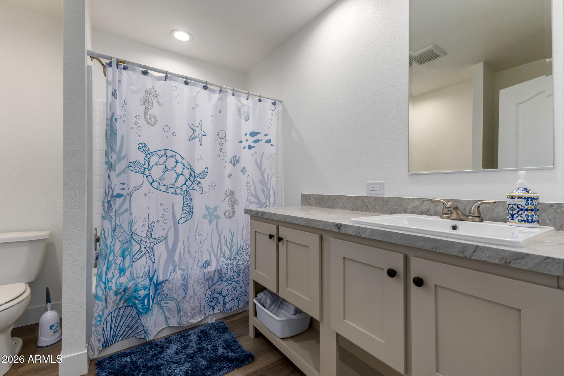 19401 North 7th Street, Unit 73 Phoenix, AZ 85024 - Photo 27 of 30 a bathroom with a granite countertop sink a toilet and a shower