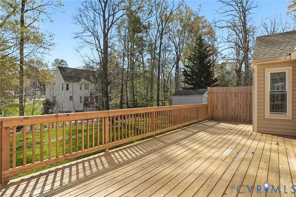 a view of a wooden deck with trees