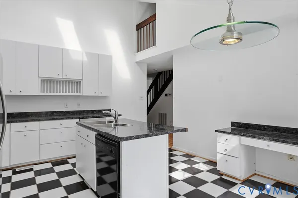a kitchen with a sink a stove and a refrigerator