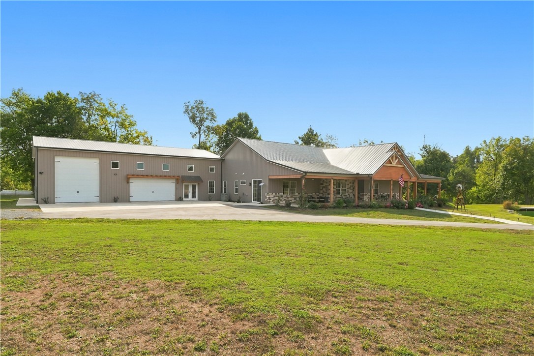 8800 Fred Austin Road Decatur, AR 72722 - Photo 40 of 60 Front view of home including garage with pull thru 14ft door for RV hookup/storage
