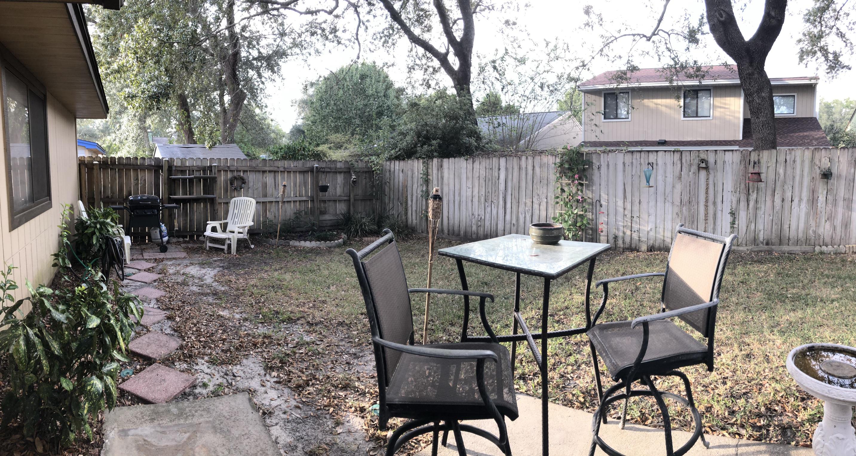206 Cedar Ridge Way Niceville, FL 32578 - Photo 12 of 12 a view of a chairs and table in backyard