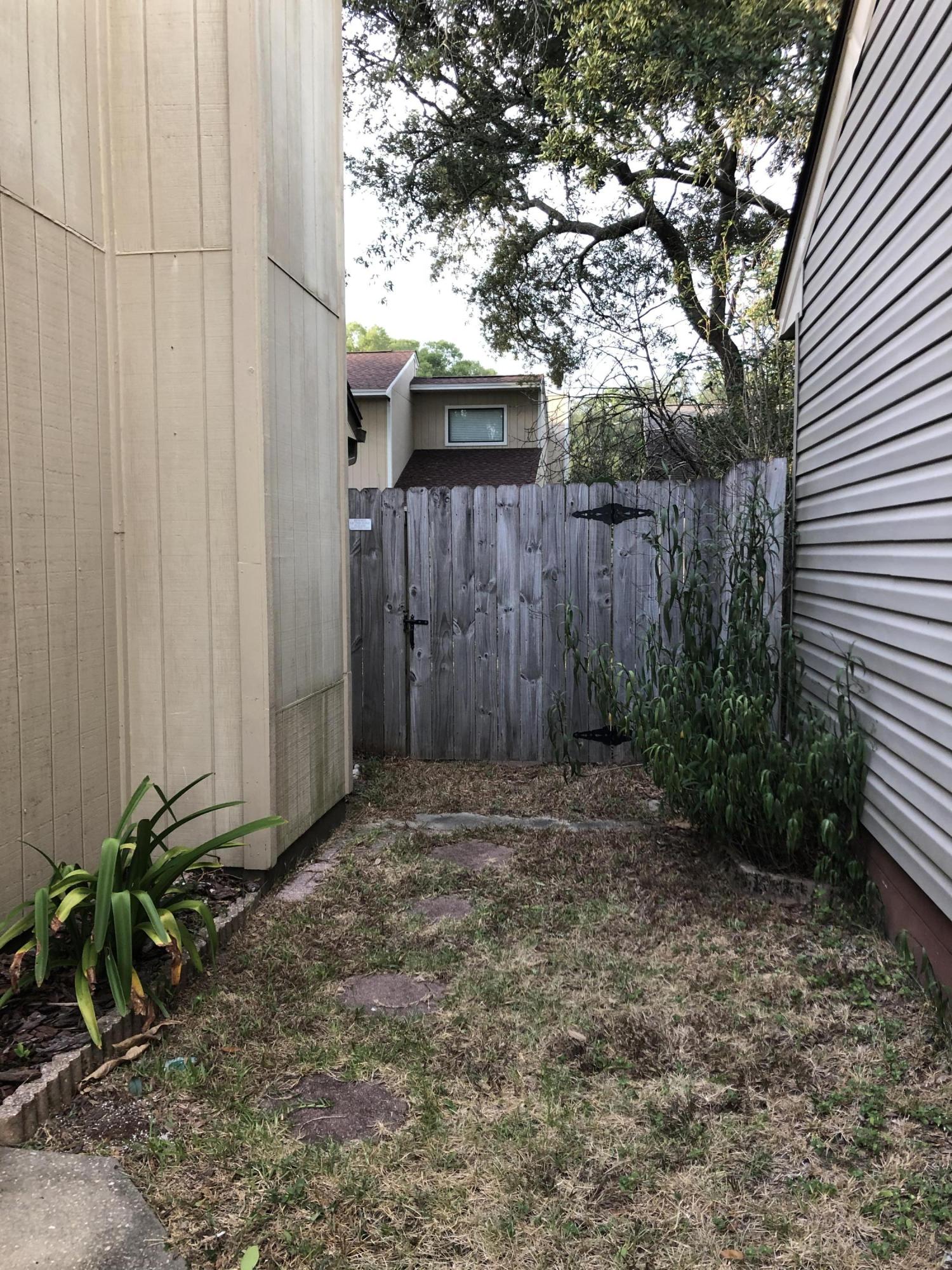 206 Cedar Ridge Way Niceville, FL 32578 - Photo 3 of 12 a view of a backyard with potted plants and large tree