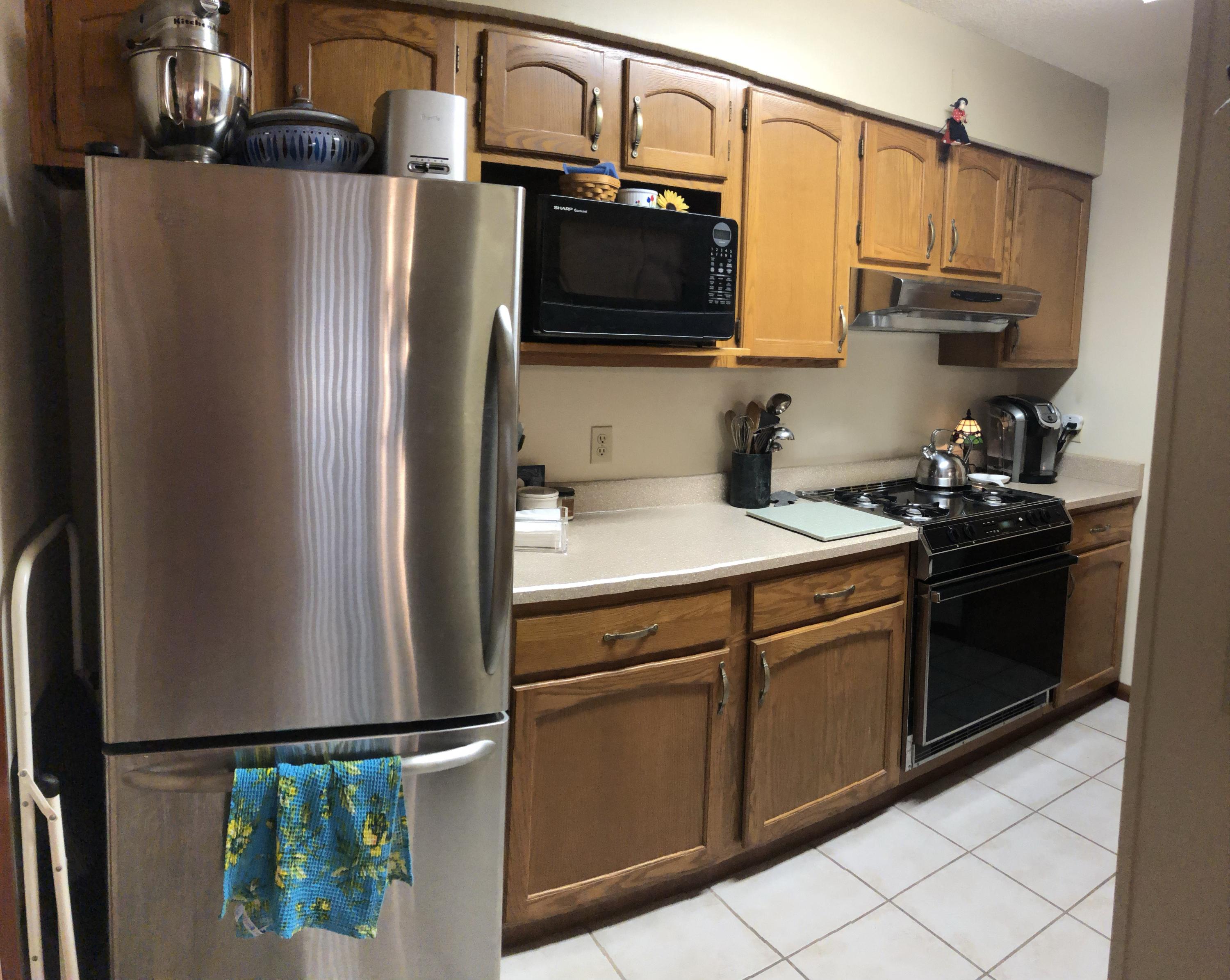 206 Cedar Ridge Way Niceville, FL 32578 - Photo 8 of 12 a kitchen with stainless steel appliances granite countertop a refrigerator a stove and a sink with wooden floor