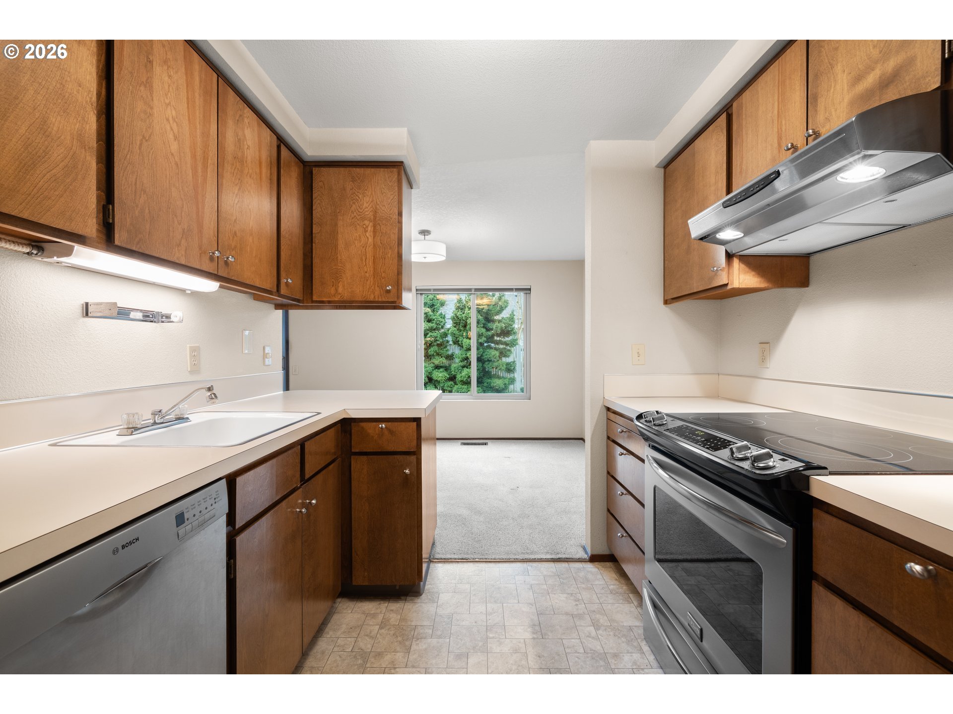 2239 Northeast 153rd Avenue Portland, OR 97230 - Photo 14 of 32 a kitchen with a sink stove top oven and cabinets