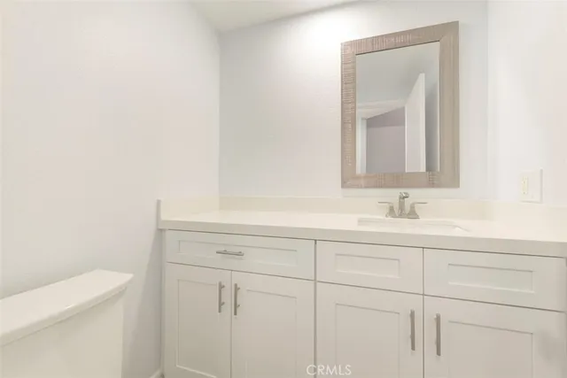 a view of empty room with wooden floor and fireplace