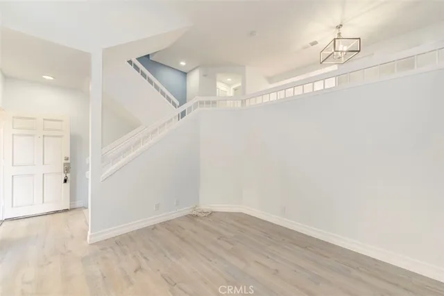 a view of a room with wooden floor