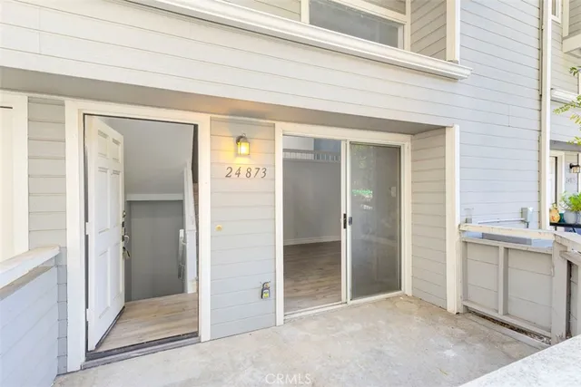 a view of a livingroom with wooden floor and a fireplace