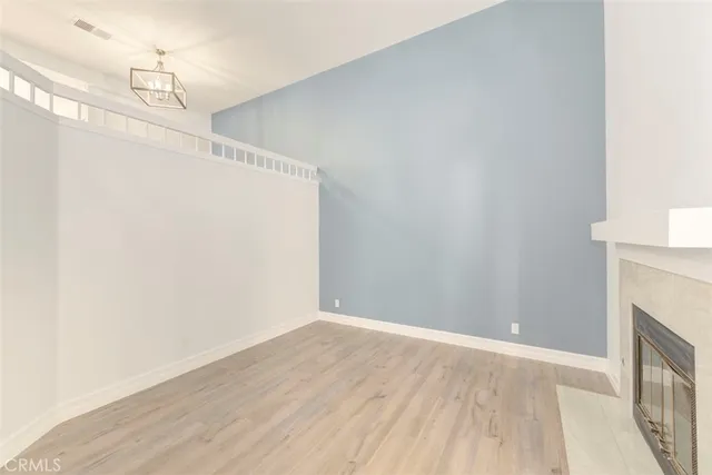 a view of a livingroom with wooden floor and window