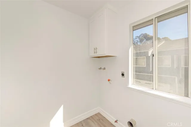 a kitchen with a sink a stove top oven a counter space and cabinets