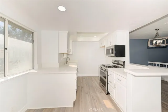a kitchen with a sink stove and microwave