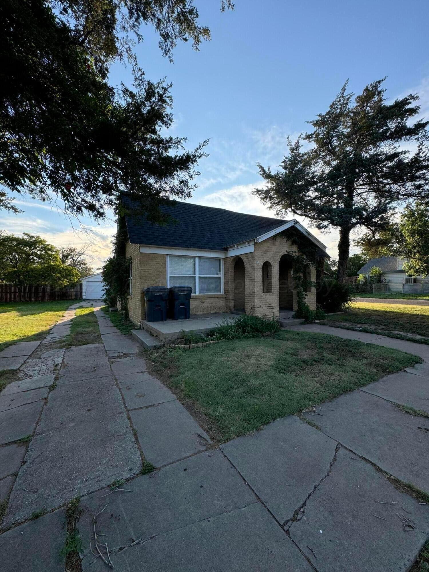 3800 South Polk Street Amarillo, TX 79110 - Photo 1 of 18 a front view of a house with garden and a tree