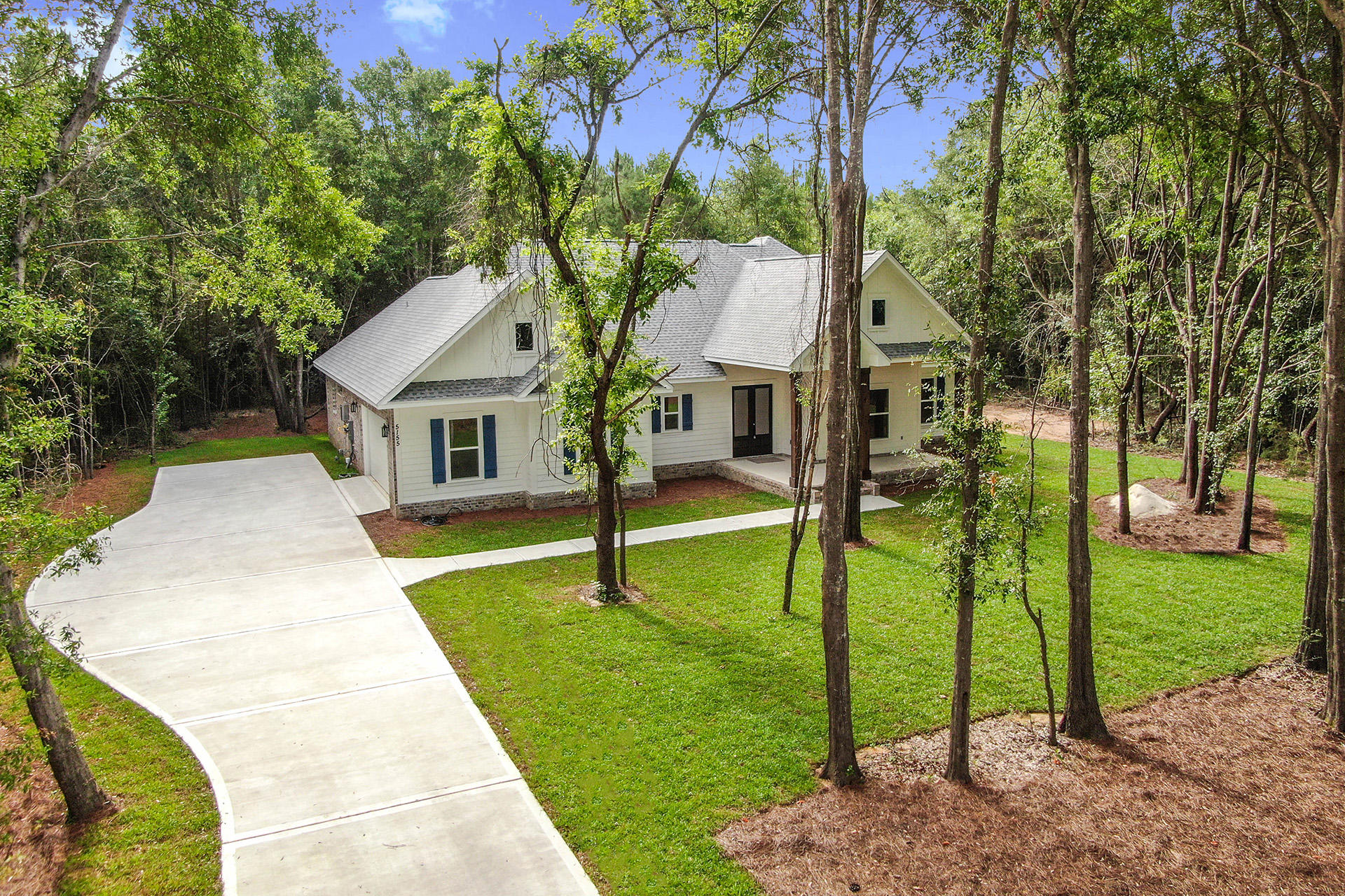 5155 Griffith Mill Road Holt, FL 32564 - Photo 1 of 56 a front view of a house with garden