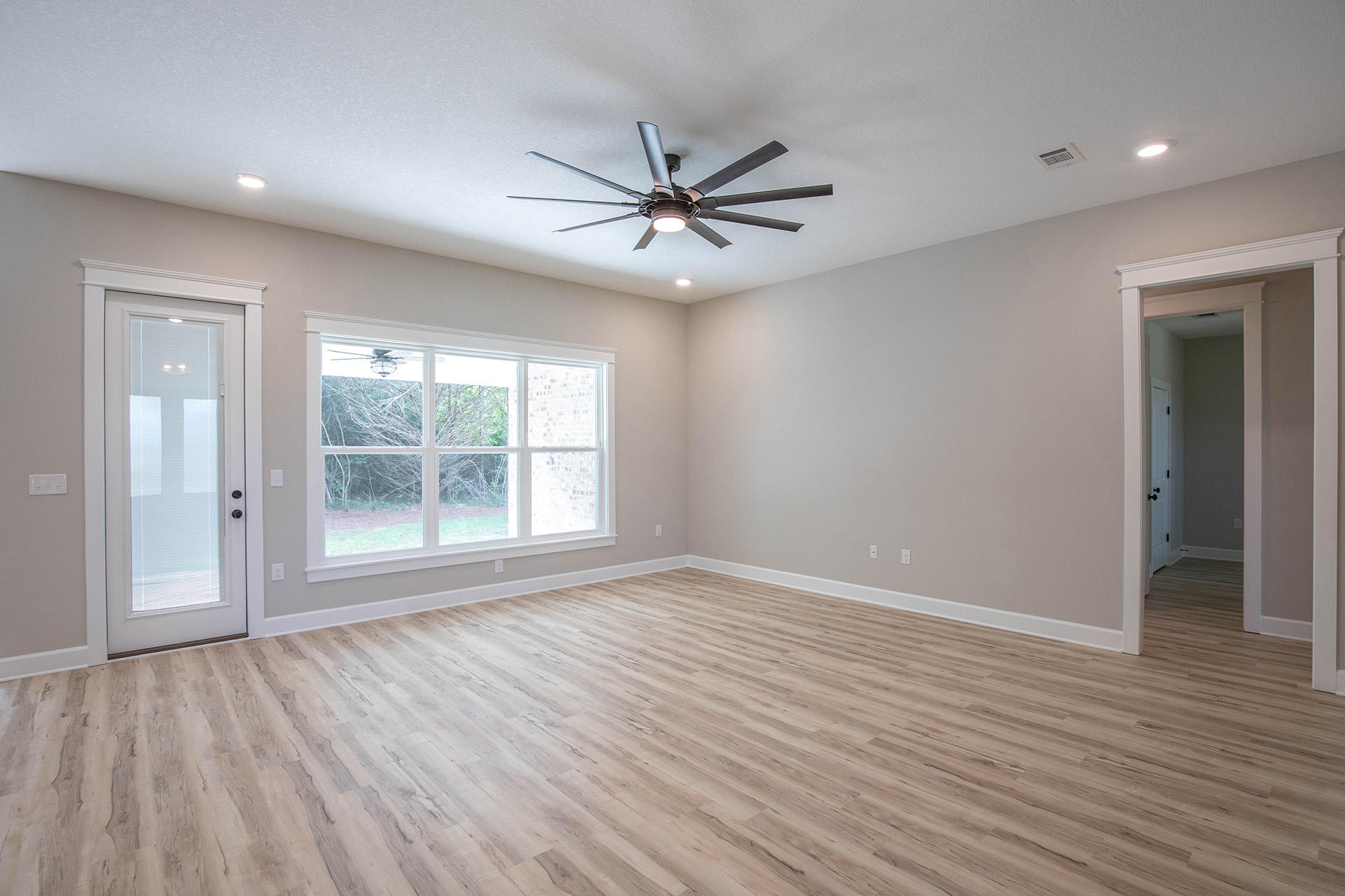 5155 Griffith Mill Road Holt, FL 32564 - Photo 13 of 56 wooden floor in an empty room with a window