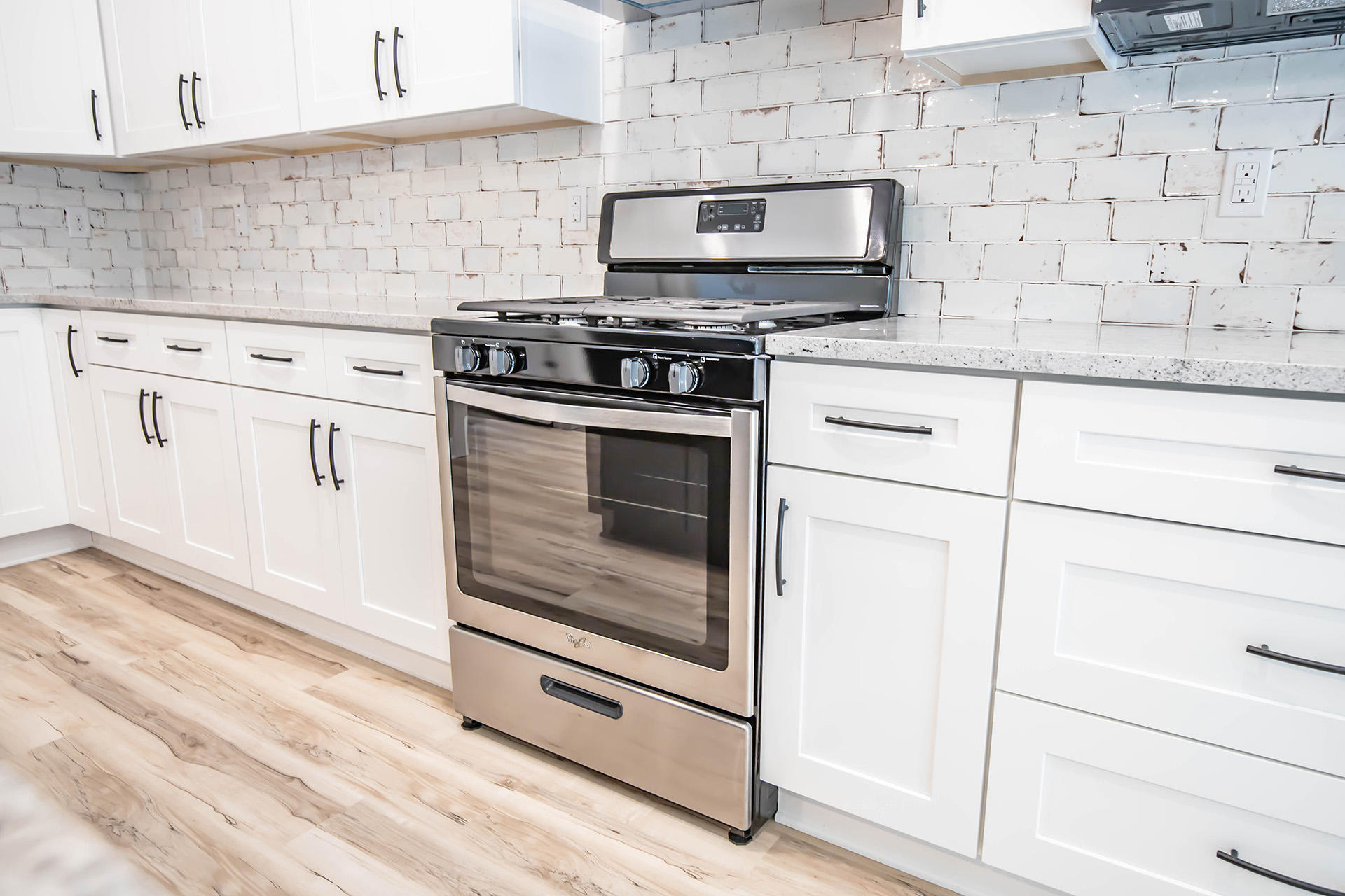 5155 Griffith Mill Road Holt, FL 32564 - Photo 21 of 56 a kitchen with granite countertop white cabinets stainless steel appliances and sink