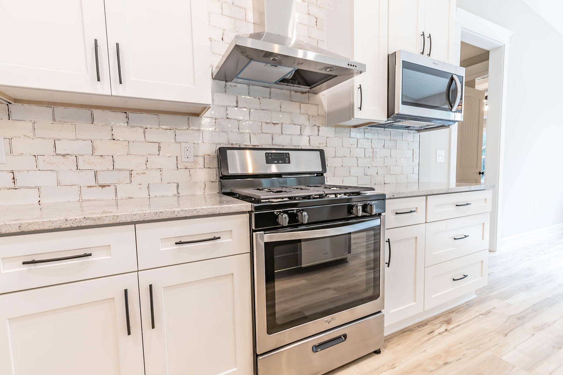 5155 Griffith Mill Road Holt, FL 32564 - Photo 23 of 56 a kitchen with white cabinets and appliances