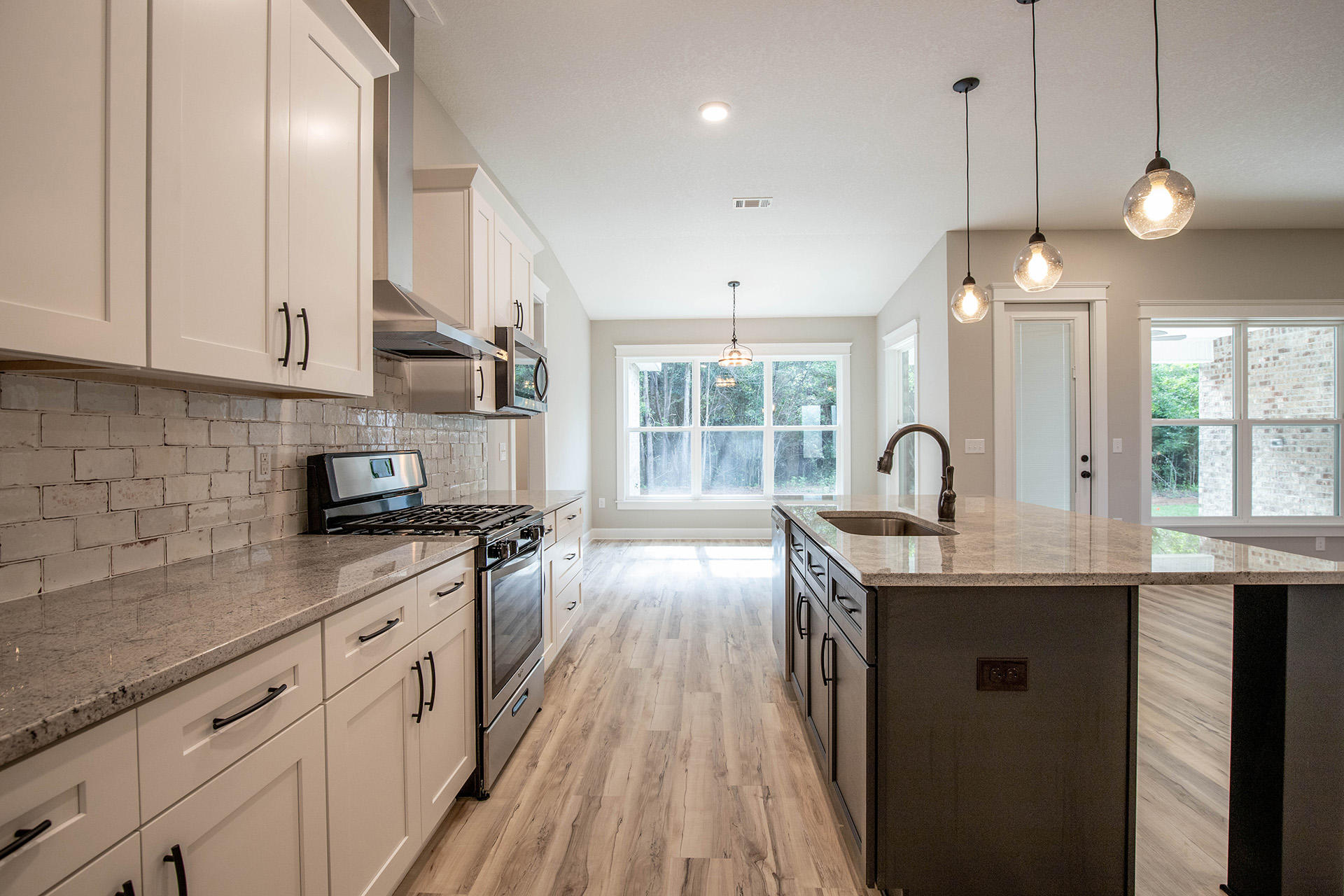 5155 Griffith Mill Road Holt, FL 32564 - Photo 26 of 56 a kitchen with stainless steel appliances granite countertop a sink a stove and a wooden floors