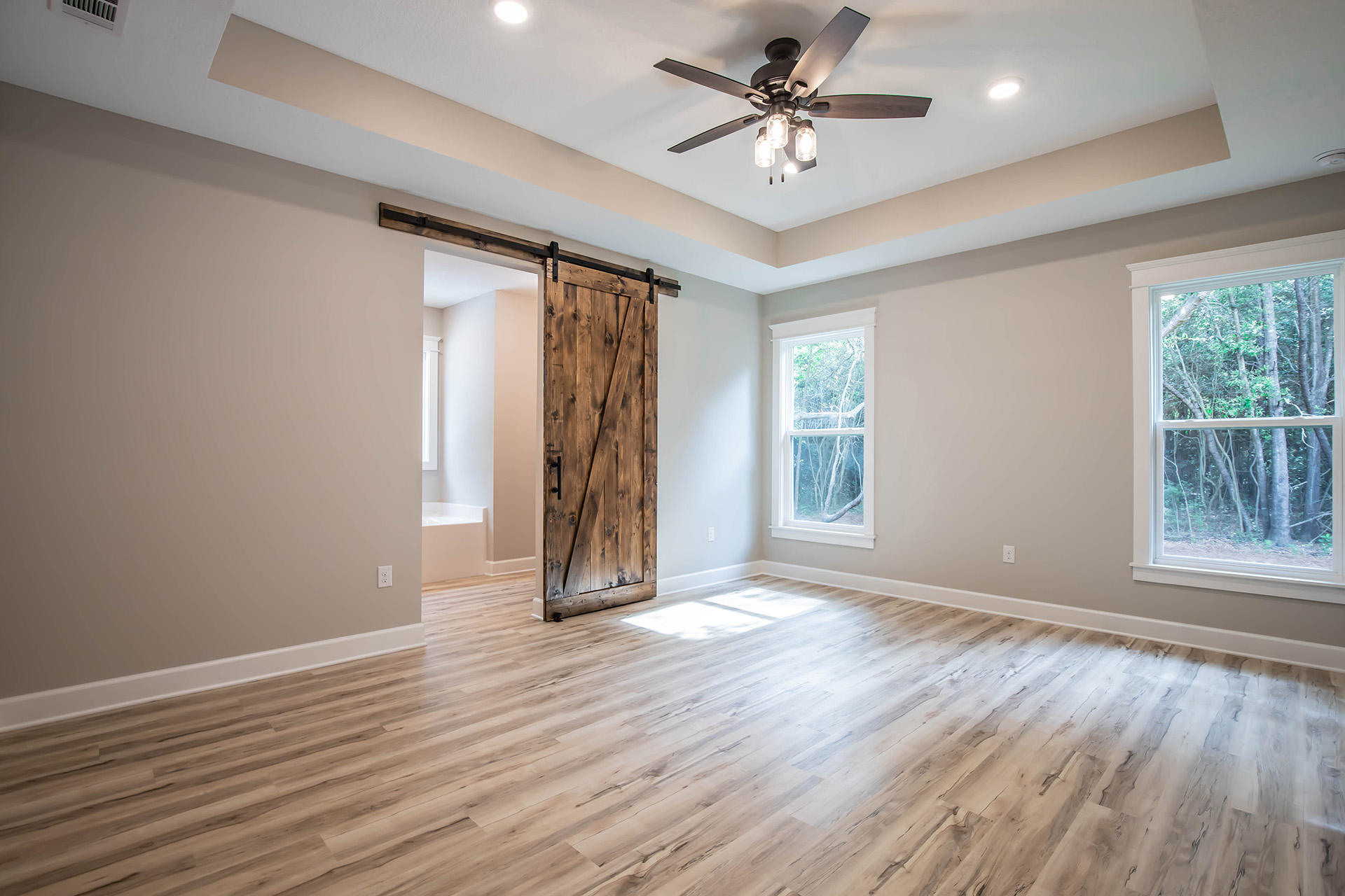 5155 Griffith Mill Road Holt, FL 32564 - Photo 28 of 56 a view of an empty room with a window and wooden floor