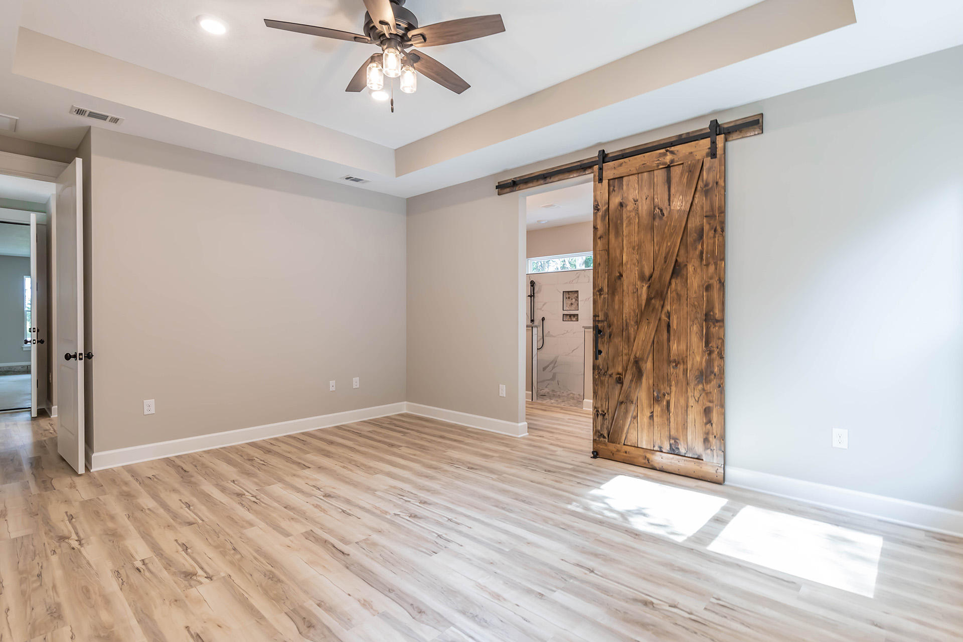 5155 Griffith Mill Road Holt, FL 32564 - Photo 29 of 56 a view of an empty room with wooden floor and a window