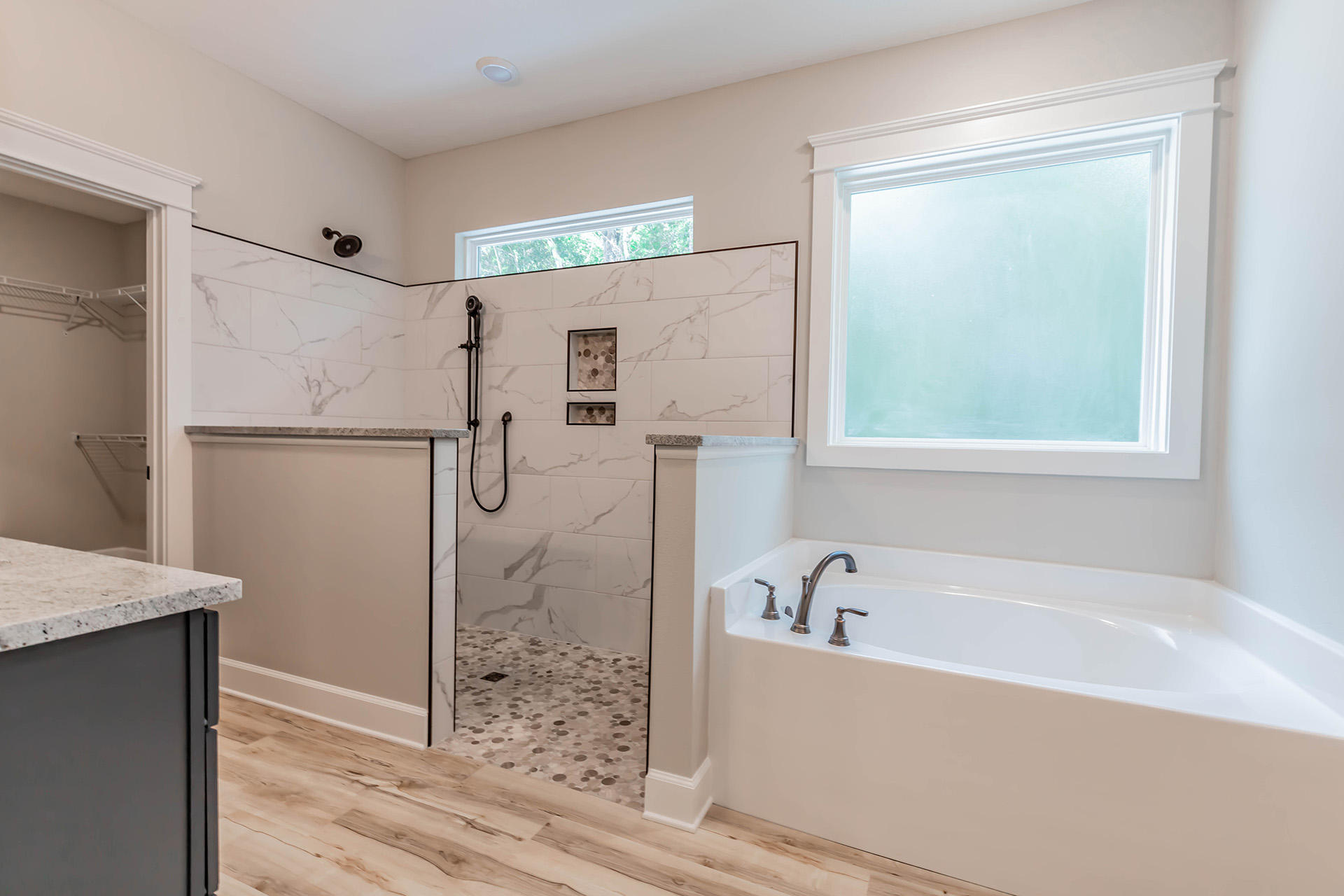 5155 Griffith Mill Road Holt, FL 32564 - Photo 31 of 56 a bathroom with a bathtub and a shower