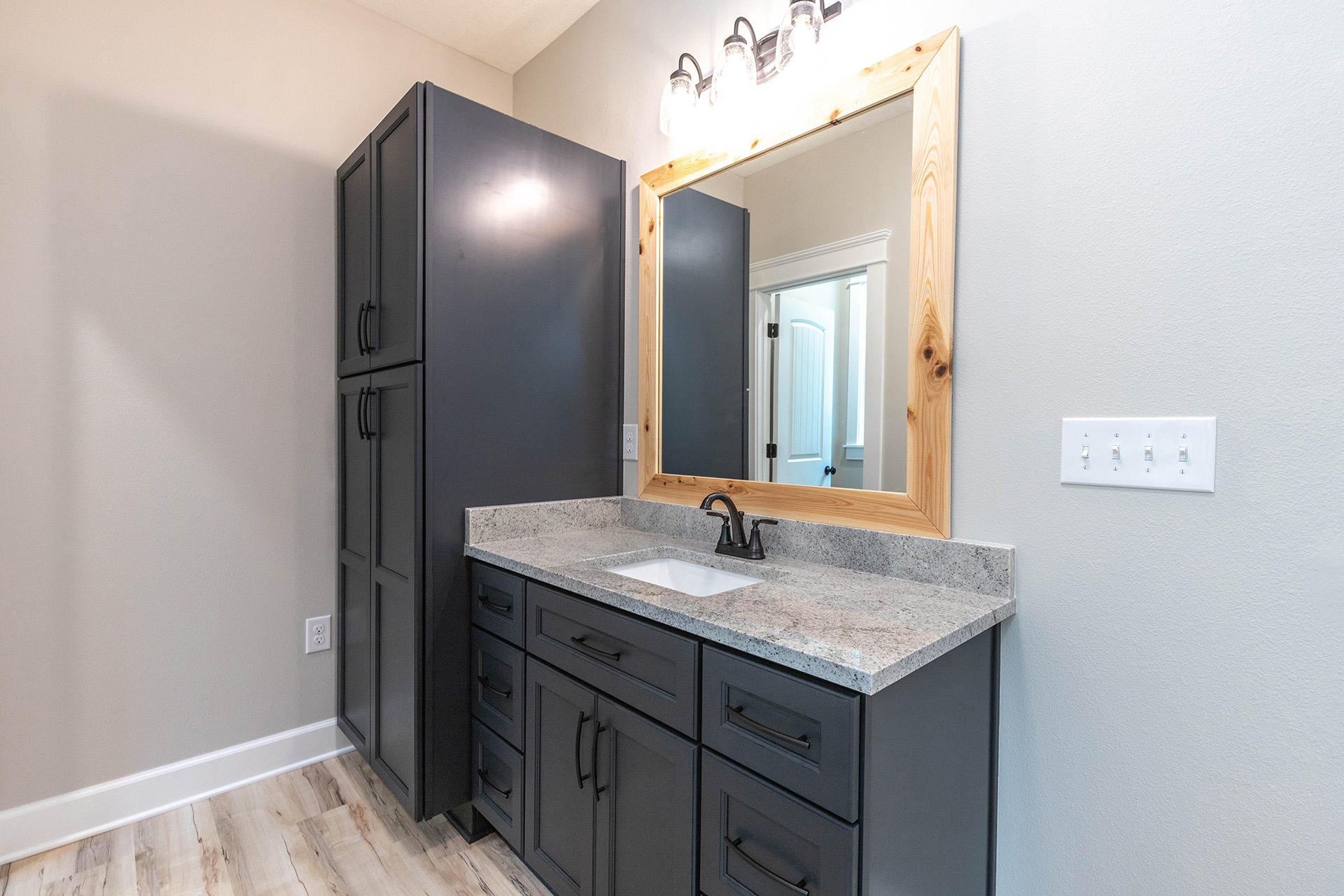 5155 Griffith Mill Road Holt, FL 32564 - Photo 34 of 56 a bathroom with a granite countertop sink and a mirror