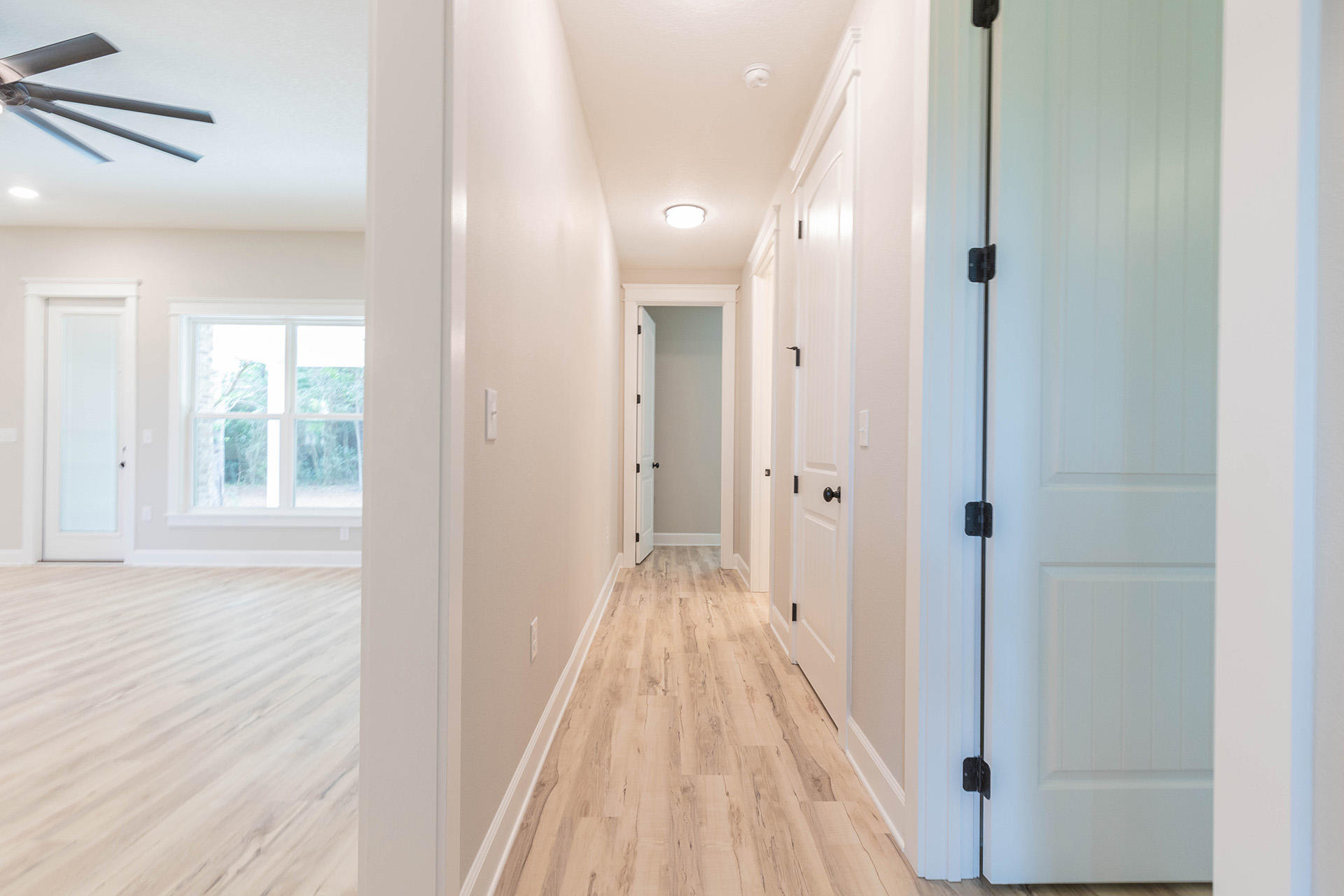 5155 Griffith Mill Road Holt, FL 32564 - Photo 42 of 56 a view of a hallway with wooden floor and a bathroom
