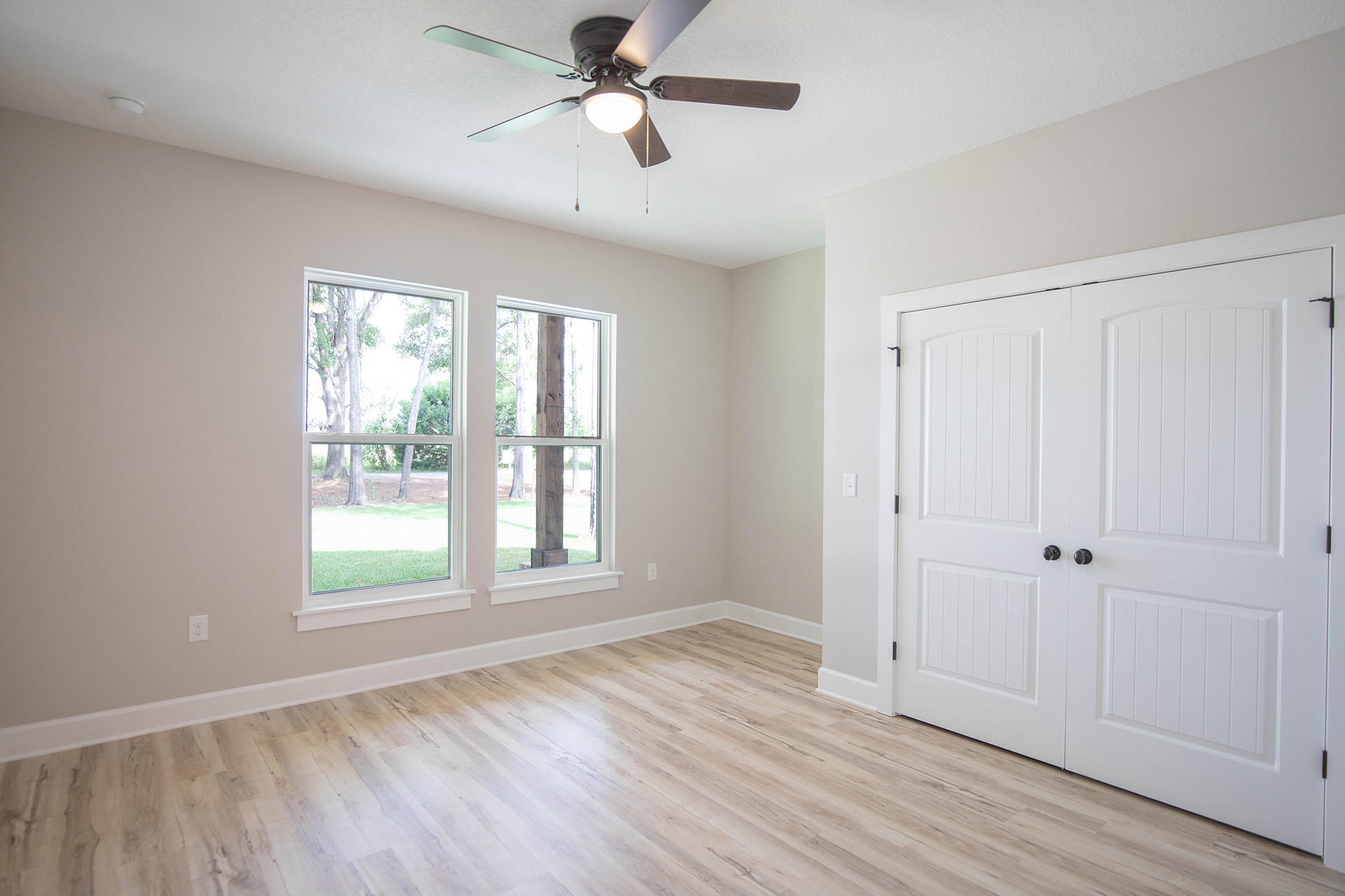 5155 Griffith Mill Road Holt, FL 32564 - Photo 43 of 56 a view of an empty room with a window and wooden floor