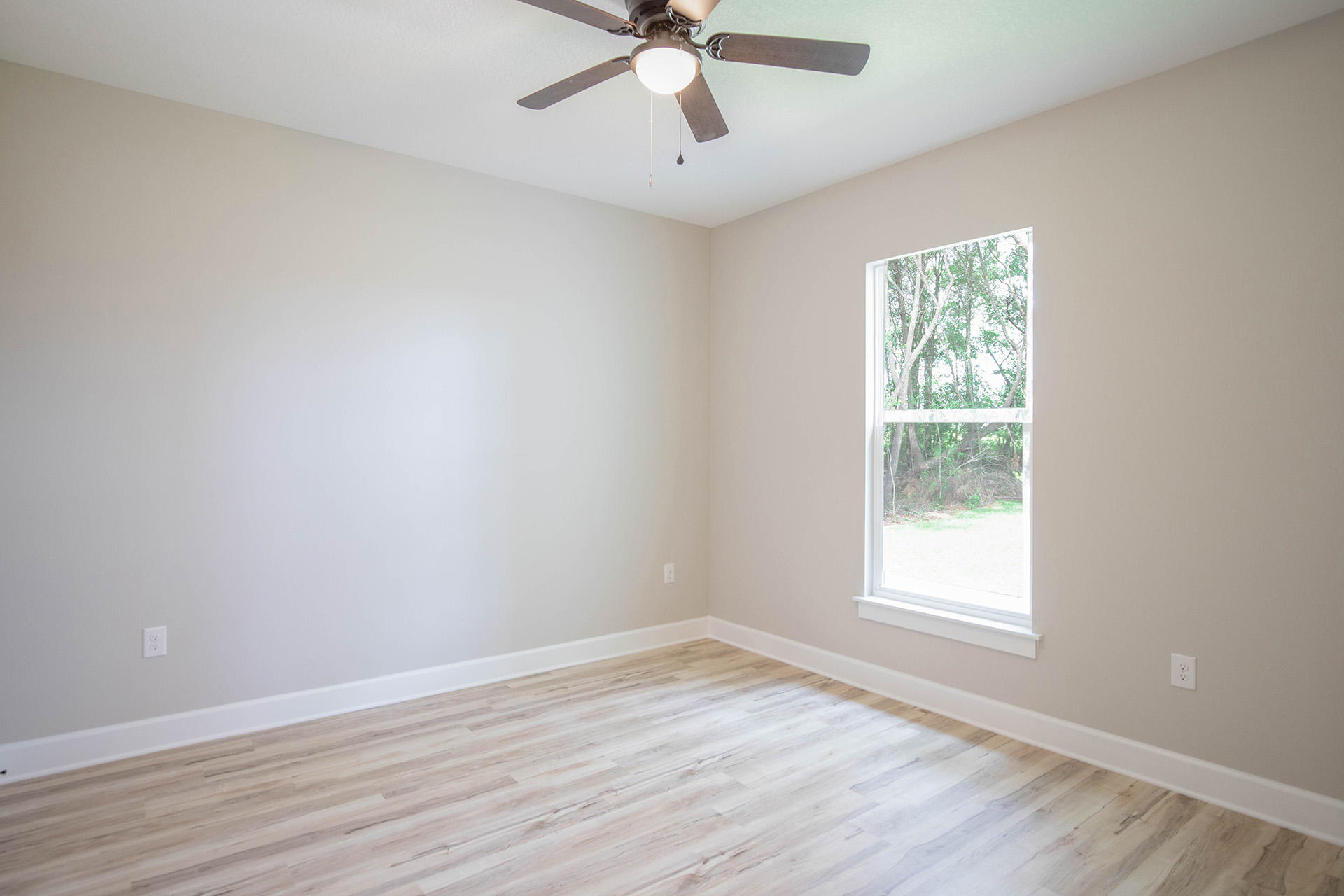5155 Griffith Mill Road Holt, FL 32564 - Photo 44 of 56 wooden floor in an empty room with a window