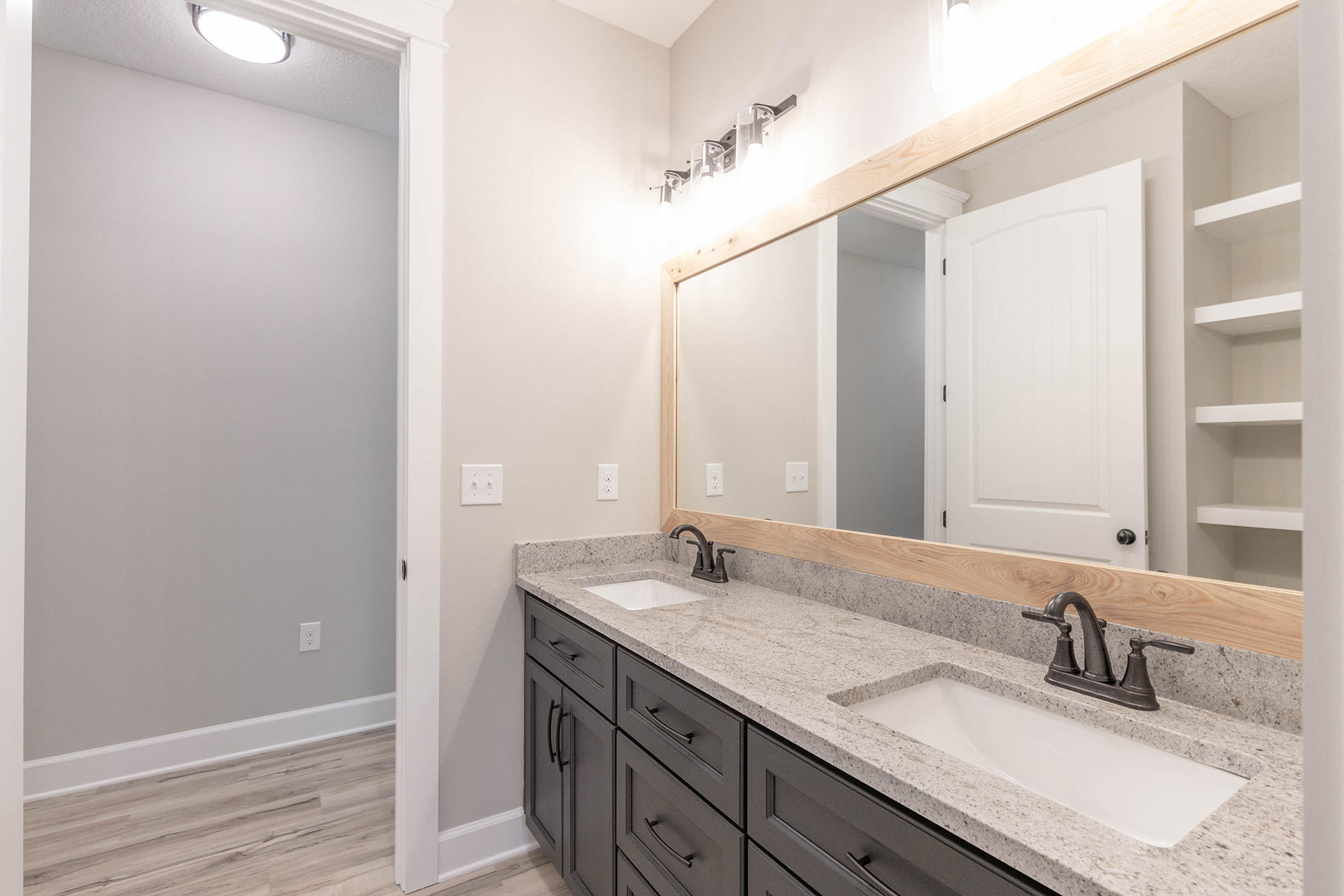 5155 Griffith Mill Road Holt, FL 32564 - Photo 45 of 56 a bathroom with a granite countertop sink and a mirror