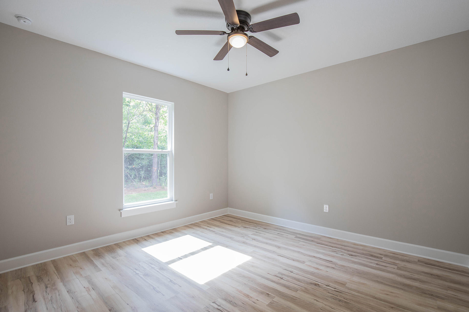 5155 Griffith Mill Road Holt, FL 32564 - Photo 47 of 56 an empty room with wooden floor and windows