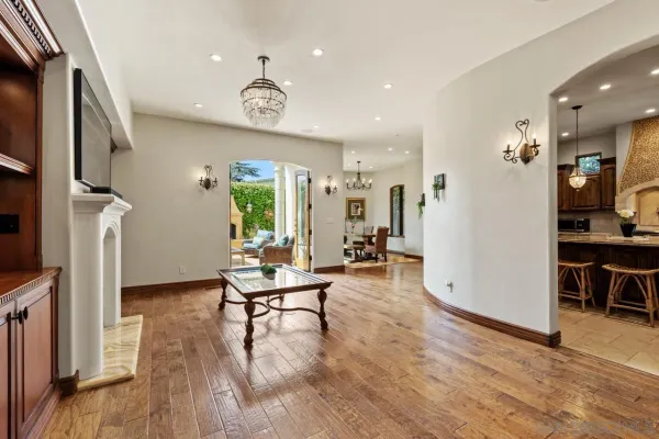 a spacious bedroom with a bed and a flat screen television