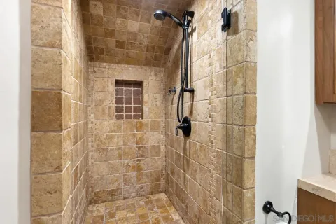 a bathroom with a tub a sink and a shower