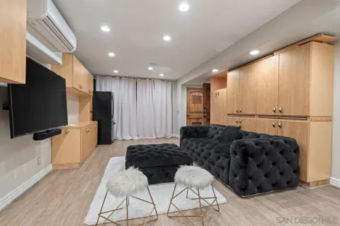 a living room with furniture a rug and a fountain