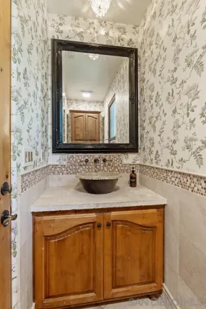 a bathroom with a granite countertop toilet sink and shower