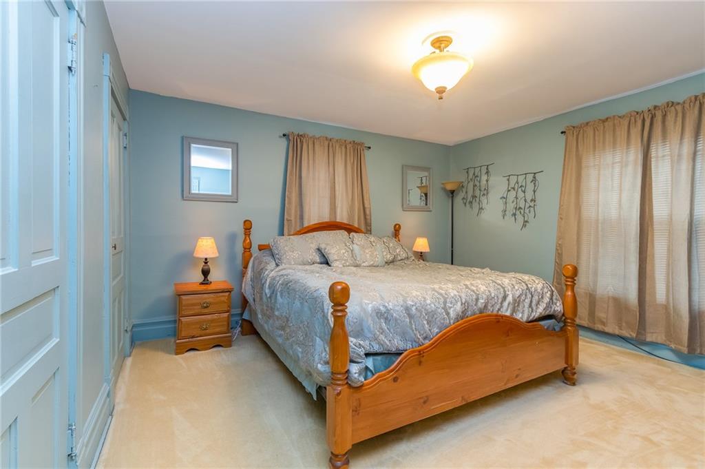 550 Virginia Avenue Rochester, PA 15074 - Photo 16 of 24 a bedroom with a bed and a chandelier