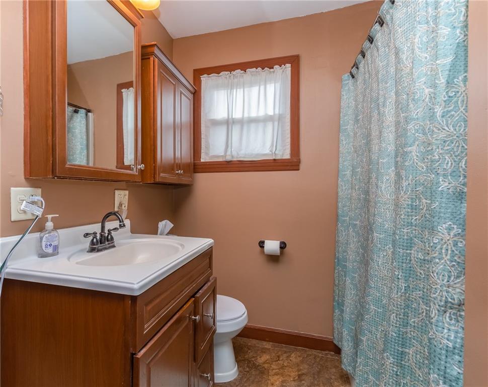 550 Virginia Avenue Rochester, PA 15074 - Photo 19 of 24 a bathroom with a sink a toilet and a mirror