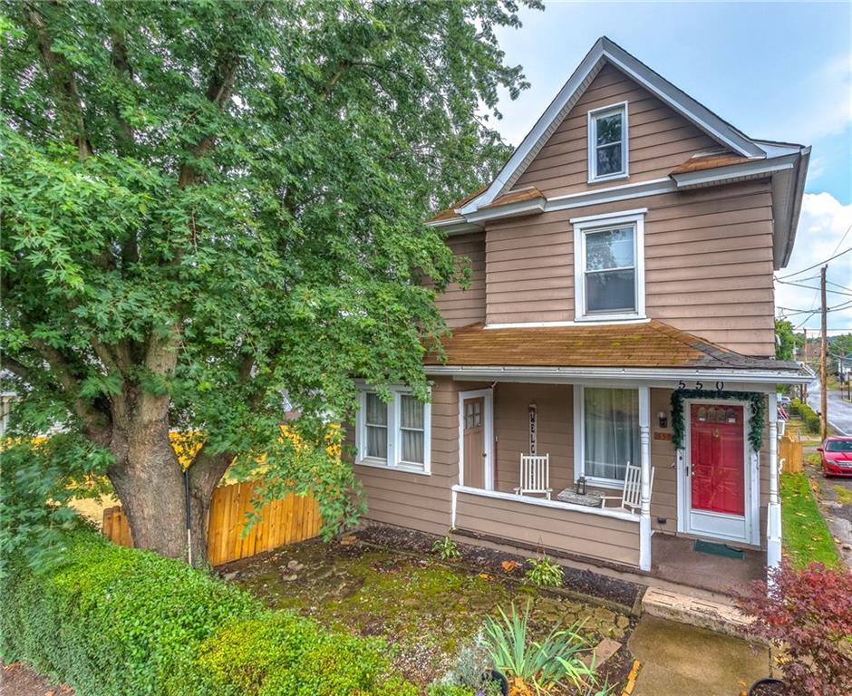 550 Virginia Avenue Rochester, PA 15074 - Photo 2 of 24 a front view of a house with a yard and potted plants