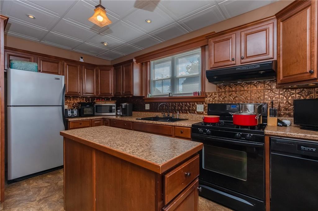 550 Virginia Avenue Rochester, PA 15074 - Photo 8 of 24 a kitchen with stainless steel appliances granite countertop a stove sink and cabinets