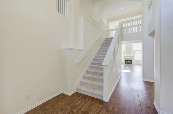 a view of a hallway with wooden floor and entryway